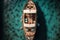 In the coral water, a vintage wooden boat. drone image of a boat