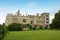 Corby, U.K., 6 May 2021. Dene Park Castle. Old big medieval traditional english castle building with green gardens panorama