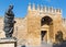 Cordoba - The statue of philosopher Lucius Annaeus Seneca the Younger by Amadeo Ruiz Olmos and medieval gate Puerta