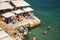 CORFU, GREECE - 10.09.2019 - Faliraki beach Alecos Baths public bathing spot with rock and pier ans restaurant in Corfu