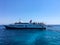 Corfu, Greece - July 7, 2018: Beautiful view of the azure Ionian Sea near the island of Paxos. People rest on the ship and swim in