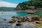 Corfu Island/Greece- May 3, 2019: view of beautiful Paleokastritsa Harbour from the beach with rocks in clear sea water, boats for