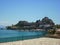 Corfu Island, Greece. Small boats port and old Kerkyra fortress in background