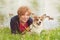 Corgi dog sitting with elderly woman in a grass