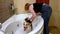 Corgi puppy bathes in the bath