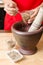 Coriander seed pounding in mortar