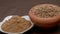 Coriander seeds in a clay bawl, and powder.