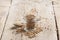 Coriander seeds in jar, dry oriental spice, rustic style, old kitchen table, selective focus