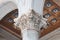 A corinthian marble capital on the facade of the cathedral of Massa, Tuscany