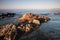 Coriscan rocks in sea at dusk