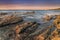 Coriscan rocks in sea at dusk