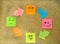 Cork board with colorful post its representing various emoticons with various emotions communication concept