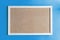 A cork board is a framed section of cork backed with wood or plastic.