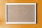 A cork board is a framed section of cork backed with wood or plastic.