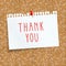 Cork board with a pinned sheet of paper in a cage. `thank you` inscription on a piece of paper. seamless background cork board