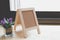 corkboard, artificial flower in small glass pot on a wooden table.