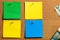 Corkboard/Bulletin Board and blank Sticky Notes in Yellow, Green and Blue, arranged orderly fashion