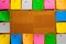 Corkboard/Bulletin Board bordered completely by very orderly placed multicolored stiky type square notes.  The notes are all blank