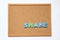 Corkboard with wording share on white background