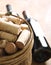 Corks in basket with bottles