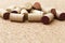 Corks from wine bottles lie in a pile on a wooden cork background. Natural wood fon with heap of corks