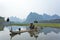 Cormorant, fish man and Li River scenery sight with fog in spring, Guilin, China