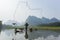 Cormorant, fish man and Li River scenery sight with fog in spring, Guilin, China