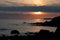 Cormorant with outstretched wings and sunset looking towards Freshwater from St Catherine`s Lighthouse, Niton, Isle of Wight