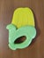 Corn baby teether on wooden background