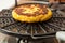 Corn bread being roasted on a round grill