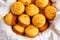 Corn bread muffins on a white and yellow dish towel