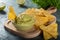 Corn chips with guacamole. A Mexican appetizer.