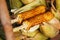 Corn cobs on the grill. Close-up image with corns and hands. Asian, Indian and Chinese street food. Trolley on the beach