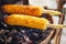 Corn cobs on the grill. Close-up image with corns and hands. Asian, Indian and Chinese street food. Trolley on the beach