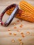 Corn cobs with manual hand tool to clean maize on wooden backgro