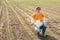 Corn crop protection concept, female farmer agronomist holding jerry can container canister with pesticide