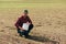 Corn crop protection concept, male farmer agronomist holding jerry can container canister with pesticide