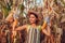 Corn crop. Young woman farmer picking corn harvest. Worker holding autumn corncobs. Farming and gardening