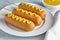 Corn dog traditional American corndog junk food fried hotdog sausage snack with mustard