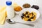 Corn flakes, dried apricots, raisins, prunes, yogurt, napkin and