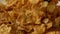 Corn flakes, dried fruits and raisin scatter on plate super slow motion video