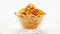 Corn flakes heap in a glass bowl rotating