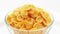 Corn flakes heap in a glass bowl rotating