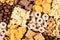 Corn flakes set - rings, stars, balls, chocolate as decorative cereals background. Top view.