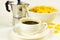 Corn flakes in white bowl, cup of black coffee espresso, geyser coffee maker on white background