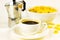 Corn flakes in white bowl, cup of black coffee espresso, geyser coffee maker on white background