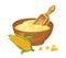 Corn flour in wooden bowl with spoon and yellow maize.