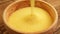 Corn Grits - corn flour poured into bowl; close up;