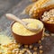 Corn groats in bowl, corn seeds and corncobs