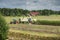 Corn harvest vehicles distant view phase 4